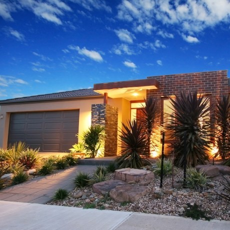Modern Australian home facade with lighting on.