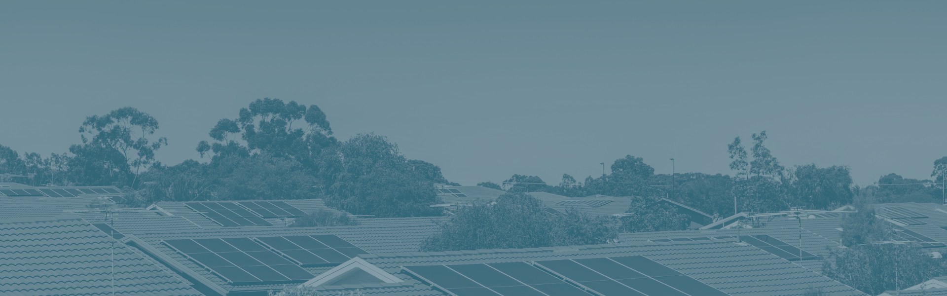 Australian home roof tops with multiple solar panels installed.