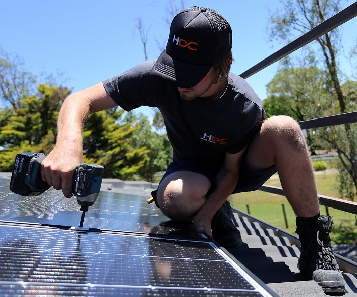 HDC staff installing solar panel on an East Melbourne home.