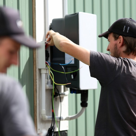 HDC Electrical and Solar technicians installing batteries and inverters.