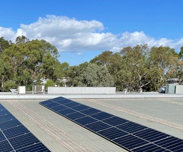 Solar panels installed on top of a Victorian business roof.